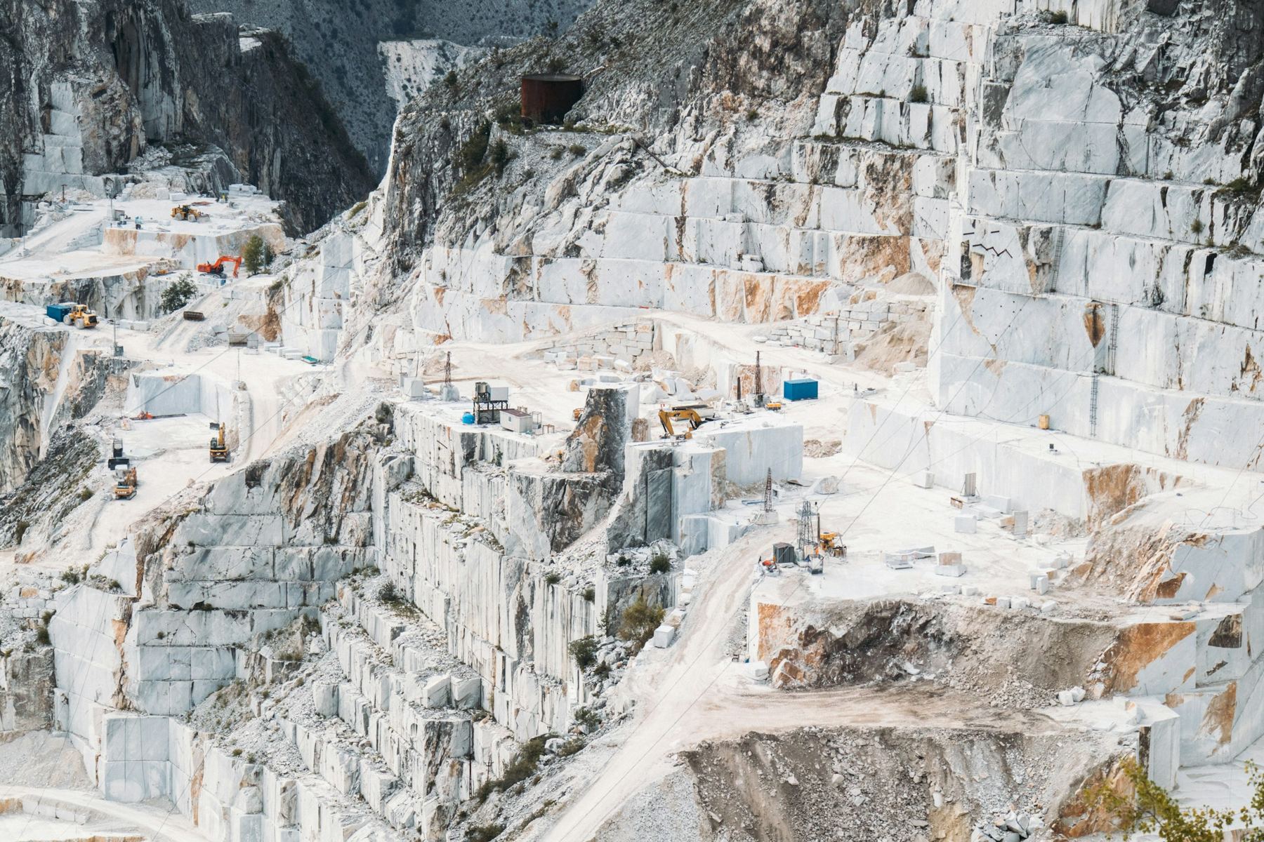 Terraced benches of a white marble quarry cut into a mountainside